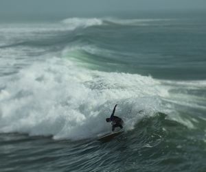 Surfer surfing on waves