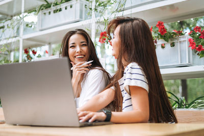 Young woman using laptop at table