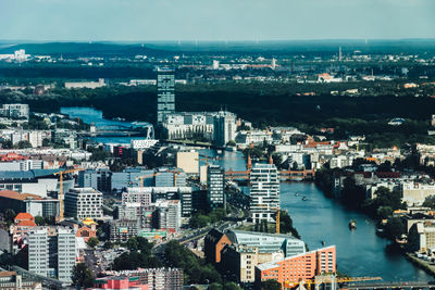 High angle view of cityscape by sea against sky