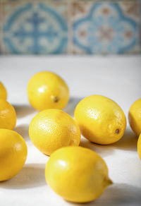 Juicy ripe lemons lie on a table covered with a linen tablecloth. selective focus.