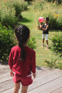 Rear view of women walking on footpath