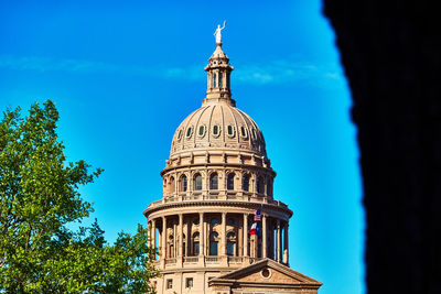 Low angle view of texas congress building against blue sky