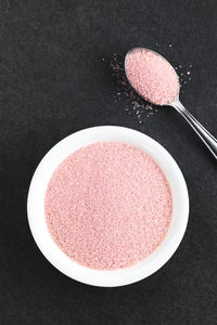High angle view of pink cake on table against black background