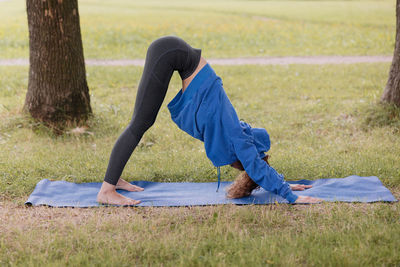 Low section of woman exercising on field