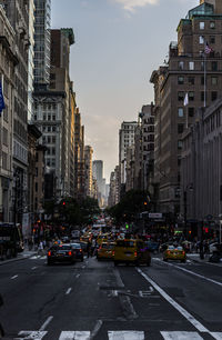 Vehicles on road along buildings