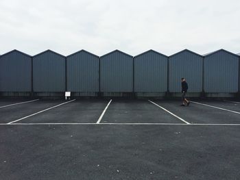 Rear view of man walking against sky