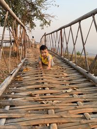 Full length of boy on footbridge