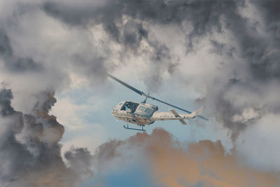 Rescue helicopter races against an oncoming storm severe weather,modern attack helicopter weapons