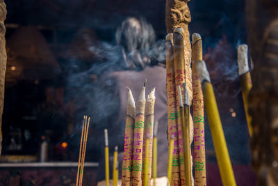 Close-up of incense sticks burning at temple