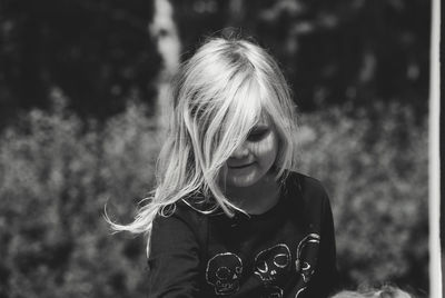 Girl standing against plants