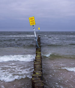 Lifeguard hut on beach against sky