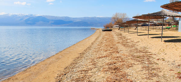 View of calm blue sea against mountain range