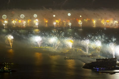 View of illuminated boats in river at night