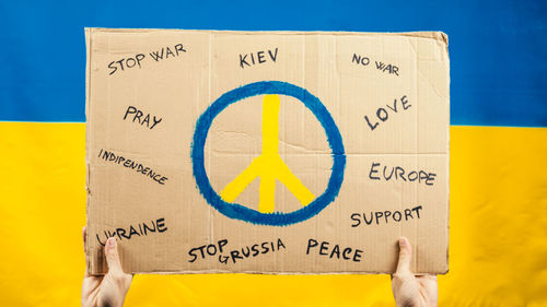 Placard with peace symbol to stop war and victims in ukraine