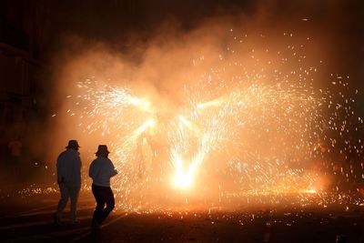 People celebrating diwali with fire crackers in the dark