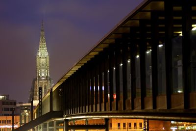 View of modern building and cathedral at night