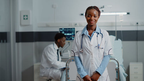 Portrait of doctor standing in ward at hospital