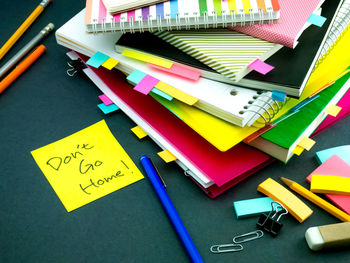 High angle view of text on paper with books at desk