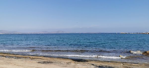 Scenic view of sea against clear blue sky