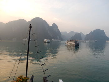 Sailboats in sea against sky