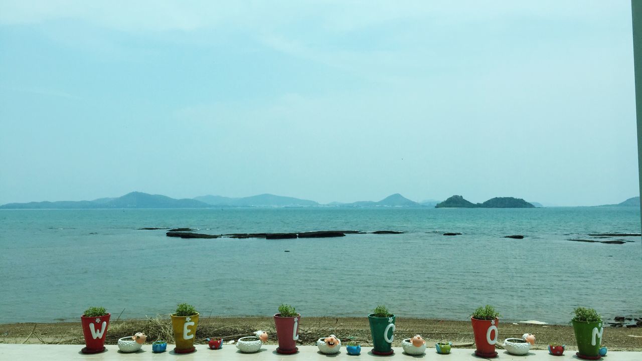 sea, water, nautical vessel, transportation, mode of transport, boat, copy space, clear sky, beach, moored, scenics, nature, tranquility, beauty in nature, horizon over water, tranquil scene, mountain, shore, sky