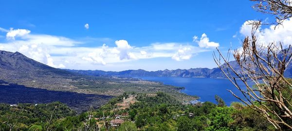 Scenic view of sea and mountains against sky