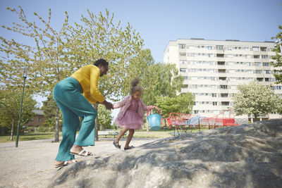 Mother and daughter playing in playground