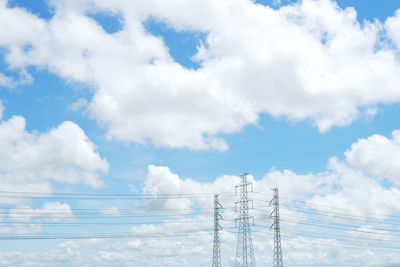 Blue sky and white cloud with high voltage electricity transmission towers and power line