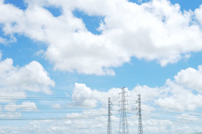 Low angle view of electricity pylon against sky