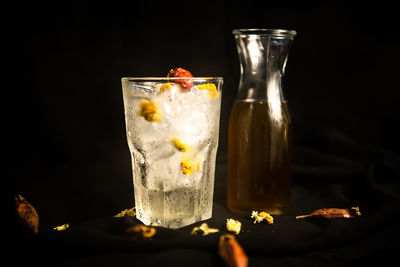 Close-up of ice cream glass on table against black background