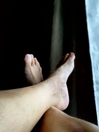 Low section of person relaxing on floor