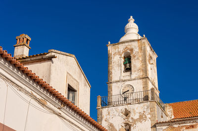 Low angle view of church building against clear blue sky