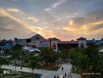 Residential buildings against sky during sunset