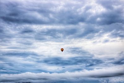 Low angle view of paragliding against sky