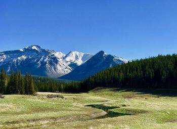 Scenic view of mountains against clear blue sky