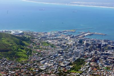 High angle view of sea and buildings in city