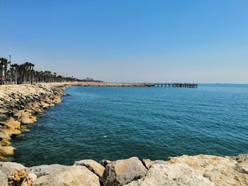 Scenic view of sea against clear blue sky