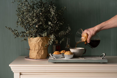 Person holding ice cream on table