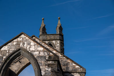 Low angle view of building against blue sky