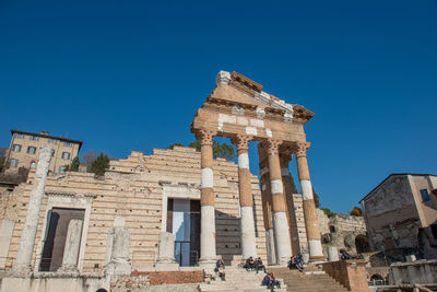 Low angle view of old building against clear blue sky