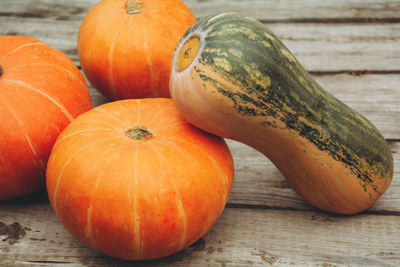 Autumn orange pumpkins on wooden planks at farm. thanksgiving and halloween season. 