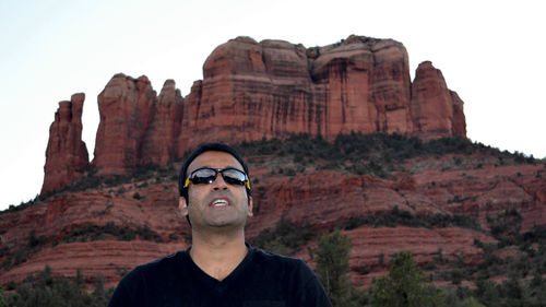 Man standing against rock formation