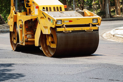 Yellow steamroller on road