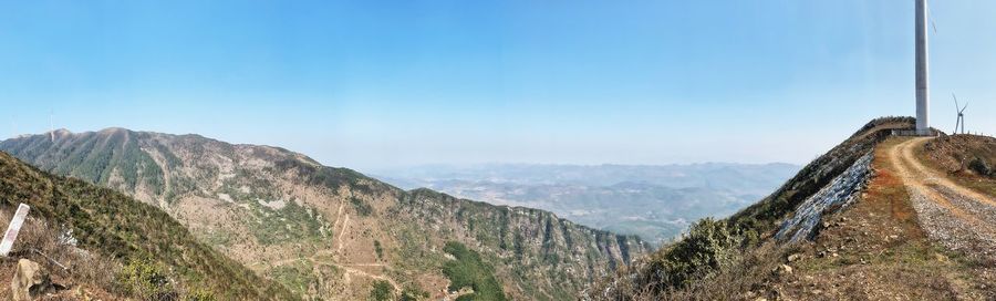 Panoramic view of mountains against clear blue sky
