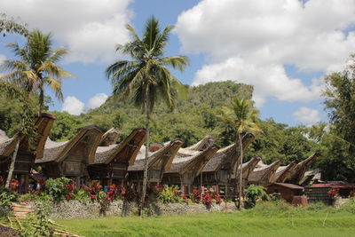 Panoramic view of trees and houses against sky