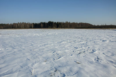 Scenic view of snow covered land against sky