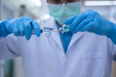 Midsection of person holding umbrella