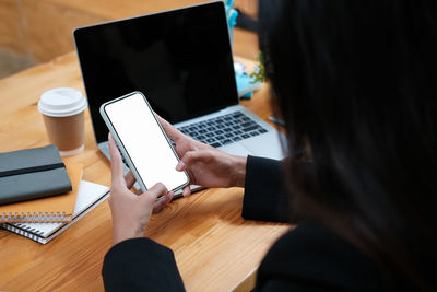 Midsection of woman using mobile phone