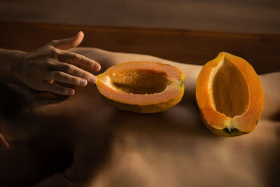 Close-up of hand holding pumpkin