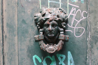 Close-up of statue against door